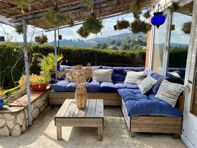 a blue couch sitting on a patio with a table at Nice Signature Baracca in Nice