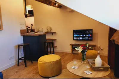 a living room with a table and a counter at MY CASA - GRIMALDI - Sous les toits de Nice in Nice