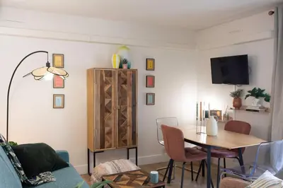 a living room with a table and a tv at #46 Terrace AC 4mins walk Sea Tram T2 Airport Port in Nice