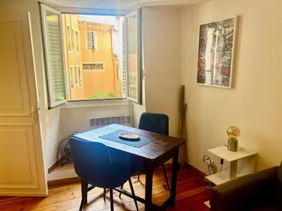 a small room with a table and a window at AA OT Cocon du Senat - Old Town in Nice