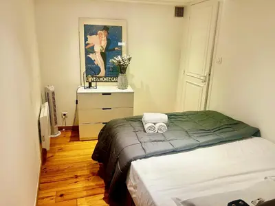 a bedroom with a bed and a painting on the wall at AA OT Cocon du Senat - Old Town in Nice
