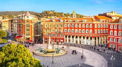 a city with a fountain in front of buildings at Splendide Nice Centre Clim in Nice