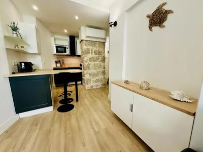 a kitchen with white cabinets and a counter top at AA G Cocon Lamartine - City center in Nice