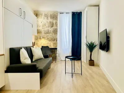 a living room with a couch and a chair at AA G Cocon Lamartine - City center in Nice