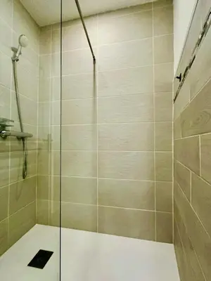 a shower with a glass door in a bathroom at AA G Cocon Lamartine - City center in Nice