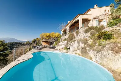 a blue swimming pool in front of a house at VILLA LAVANDINE - Maison Provencale avec Piscine - Magnifique vue in Aspremont