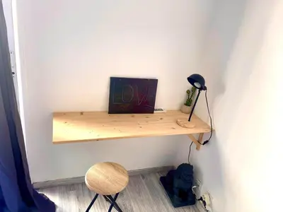 a shelf on a wall with a painting and a lamp at Fully-equipped 2-bedroom apartment in Nice