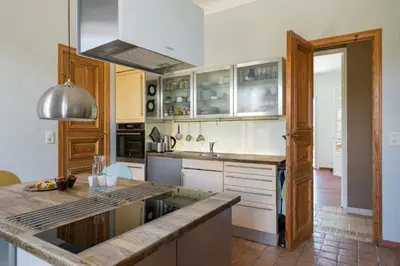 a kitchen with white cabinets and a counter top at Sea View Villa In The Hills Of Nice in Nice