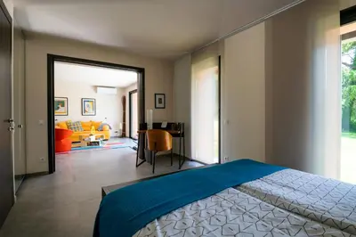 a bedroom with a bed and a living room at Sea View Villa In The Hills Of Nice in Nice