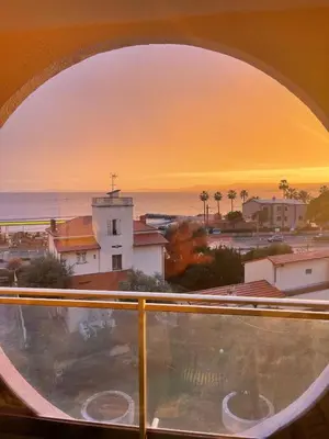 a view of the ocean from a window at Sea View Apartment 50 m to Beach FREE Parking in Cagnes-sur-Mer