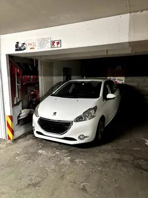 a white car is parked in a garage at Sea View Apartment 50 m to Beach FREE Parking in Cagnes-sur-Mer