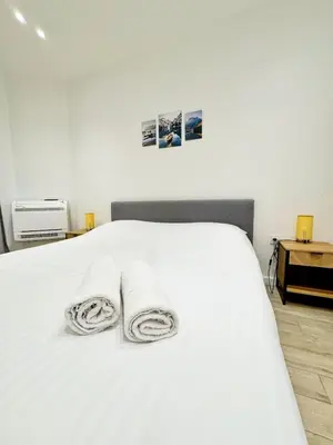 a bedroom with a white bed with towels on it at RF105 - Authentique 3P Nice centre in Nice