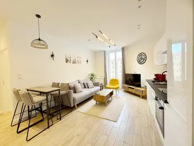a living room with a couch and a table at RF105 - Authentique 3P Nice centre in Nice