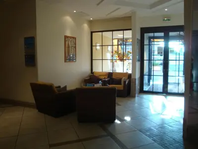 a lobby with couches and chairs in a building at Appartement Résidence Héliotel in Saint-Laurent-du-Var