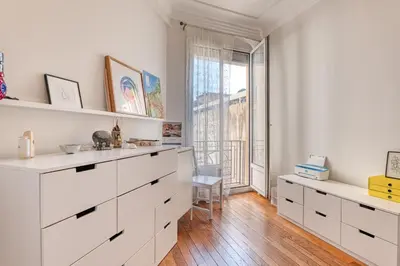 a white kitchen with white cabinets and a window at Cocon D'Azur - 5min from the beach - Happy Rentals in Nice