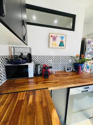 a kitchen counter with a wooden counter top at Nice experience in Nice