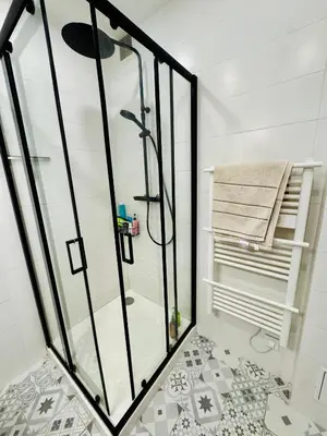 a shower with a glass door in a bathroom at Nice experience in Nice