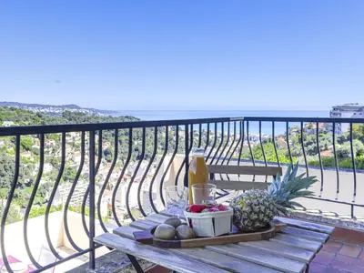 a picnic table with a drink and fruit on a balcony at Holiday Home Villa la Bergerie by Interhome in Nice
