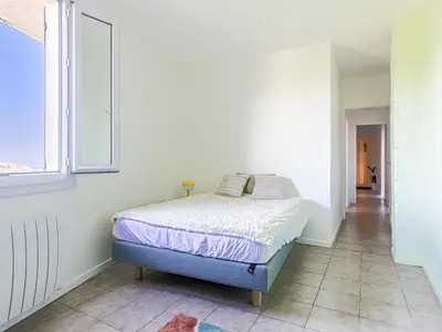 a white bedroom with a bed and a window at Holiday Home Villa la Bergerie by Interhome in Nice