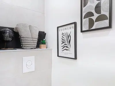 a room with two pictures on the wall and a shelf at Apartment Le Nice Etoile by Interhome in Nice