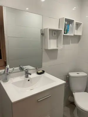a white bathroom with a sink and a toilet at Appartement 2 pièces à 5 mn de la plage N3 in Saint-Laurent-du-Var