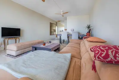 a living room with a couch and a tv at Le rêve bleu in Nice