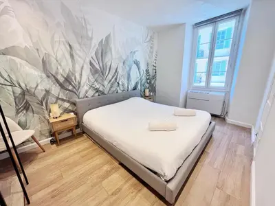 a bedroom with a bed with a mural on the wall at RF104 - Charmant 3P à nice près du Port in Nice