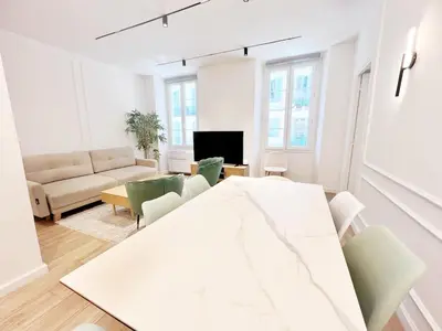 a white living room with a white table and chairs at RF104 - Charmant 3P à nice près du Port in Nice