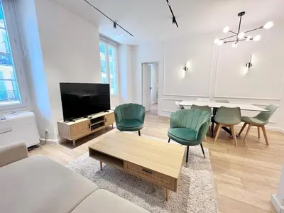 a living room with a table and green chairs at RF104 - Charmant 3P à nice près du Port in Nice