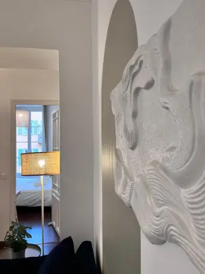 a large white sculpture on the wall of a room at RF109 - Spacieux 4P au cœur de Nice in Nice
