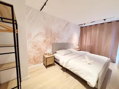 a bedroom with a bed and a wall with a mural at RF112 - T3 Lumineux à deux pas du port in Nice
