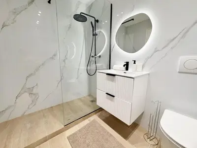 a bathroom with a shower and a sink and a mirror at RF112 - T3 Lumineux à deux pas du port in Nice