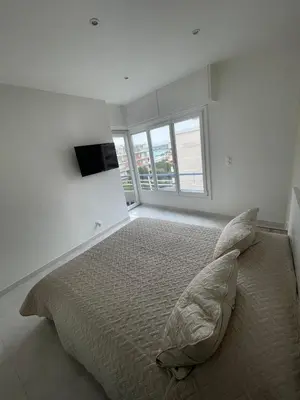 a bedroom with a large bed with a large window at Sea view apartment in Cagnes-sur-Mer
