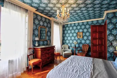 a bedroom with a bed and a desk and a chair at Villa La Rara Beaulieu Centre in Beaulieu-sur-Mer