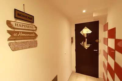a hallway with a black door and signs on the wall at AERO Nice in Nice