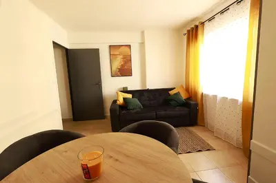 a living room with a table and a couch at AERO Nice in Nice