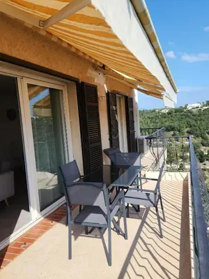 a table and chairs on the balcony of a house at Superbe appartement vue mer in Cagnes-sur-Mer