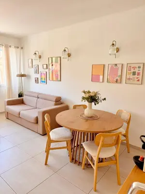 a living room with a table and chairs and a couch at Chic & cosy proche mer in Nice