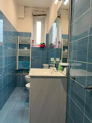 a blue bathroom with a sink and a toilet at Appart Le Carré D'Or in Nice
