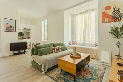 a living room with a couch and a table at Nice Magnan, Appartement proches plage et tramway in Nice