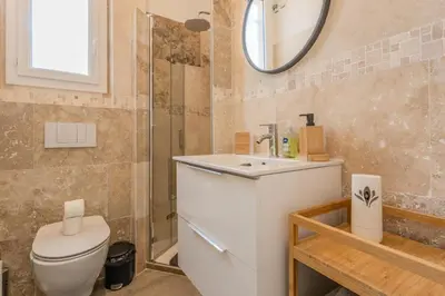 a bathroom with a toilet and a sink and a mirror at Nice Magnan, Appartement proches plage et tramway in Nice