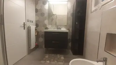a bathroom with a toilet and a sink and a mirror at Apartment Palais de Coppet in Nice