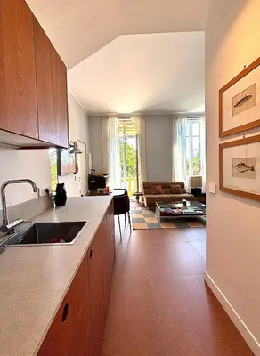 a kitchen with a sink and a living room at Elegant apartment, Cap de Nice in Nice