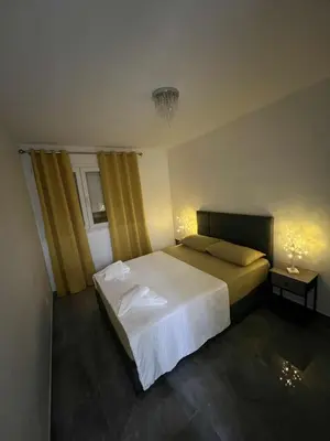 a bedroom with a large bed and two night stands at Appartement Luxe & design Vue mer sur la Promenade des Anglais in Nice