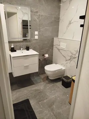 a bathroom with a toilet and a sink and a mirror at Appartement Luxe & design Vue mer sur la Promenade des Anglais in Nice