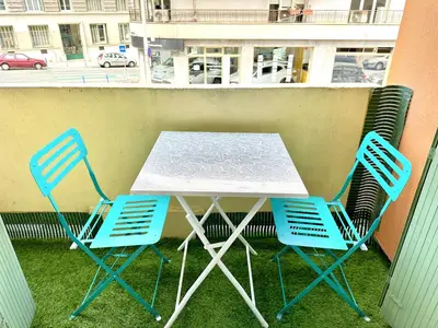 a table and chairs on a balcony with a street at Studio Riviera - balcon et Wifi in Nice