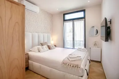 a bedroom with a large white bed and a window at #52 Etoile Suite ,Central, Balcony, AC-5 min P Massena in Nice