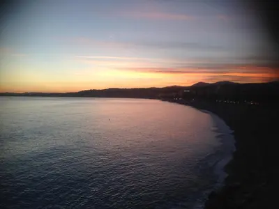a view of the ocean at sunset at Long stay in Old town of Nice, Castle Hill in Nice