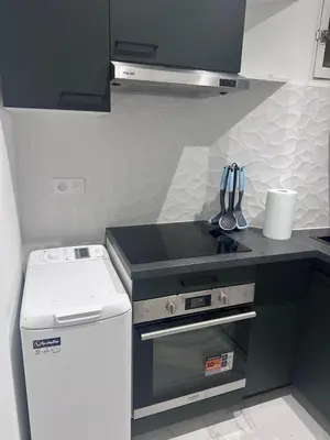 a small kitchen with a stove and a refrigerator at Beautiful and super central in Nice
