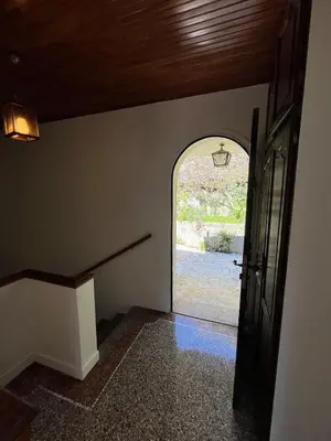 an empty hallway with an archway and a door at Seaside Jungle Retreat in Nice